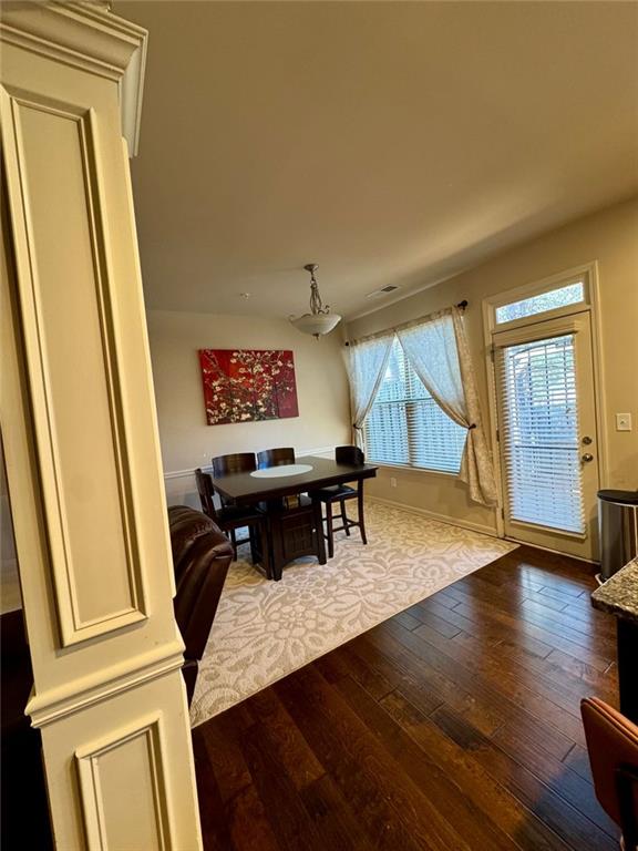 dining area featuring wood-type flooring and baseboards