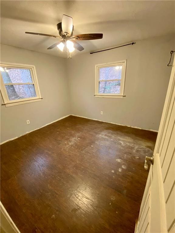 unfurnished bedroom with a ceiling fan and dark wood finished floors