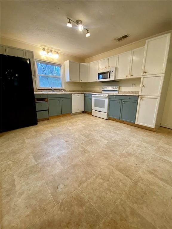 kitchen featuring light countertops, white appliances, visible vents, and green cabinets