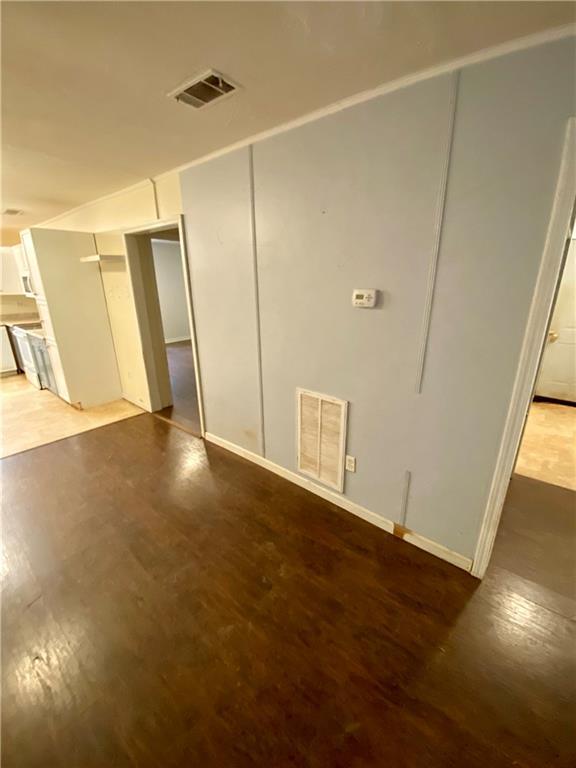 unfurnished bedroom featuring light wood-style flooring and visible vents