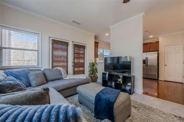 living room featuring ornamental molding and wood-type flooring