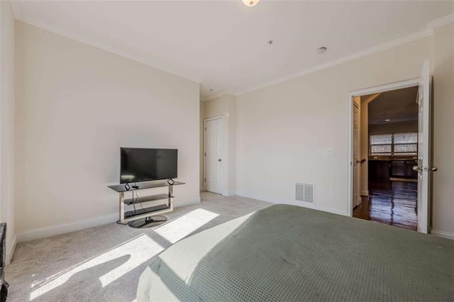 carpeted bedroom with ornamental molding