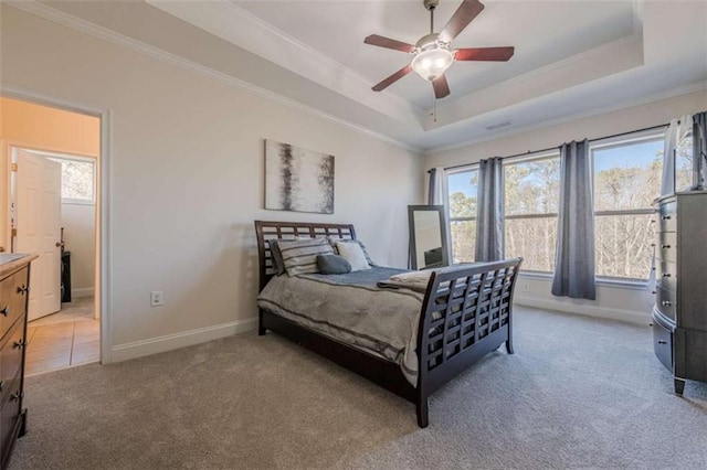 carpeted bedroom featuring ornamental molding, a raised ceiling, and ceiling fan