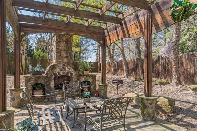 view of patio featuring a pergola and an outdoor stone fireplace