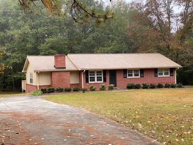 2194 Klondike Rd SW, Conyers, GA 30094 - single story home featuring brick siding, a chimney, a front yard, and concrete driveway