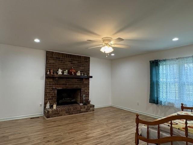 2194 Klondike Rd SW, Conyers, GA 30094 - living room with ceiling fan, baseboards, wood finished floors, a fireplace, and recessed lighting