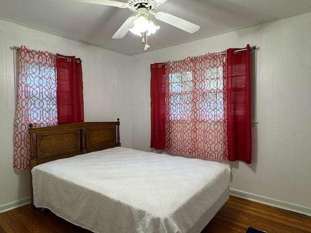 bedroom with dark wood-type flooring and ceiling fan