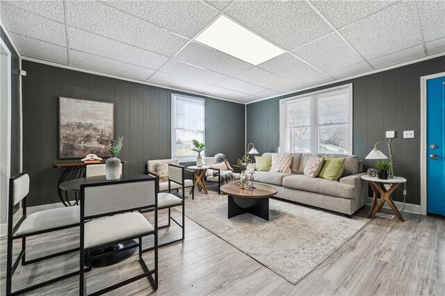 living room featuring hardwood / wood-style floors and a drop ceiling