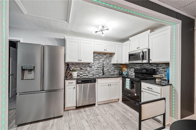 kitchen with appliances with stainless steel finishes, sink, and white cabinets