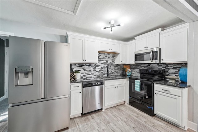 kitchen featuring stainless steel appliances, sink, and white cabinets