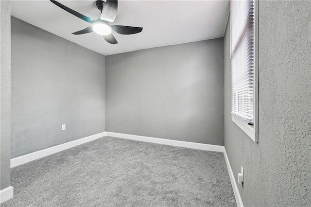 empty room with carpet floors and ceiling fan