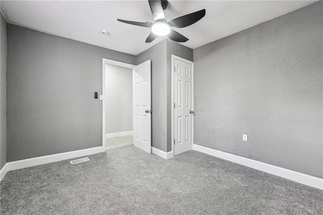 unfurnished bedroom featuring carpet flooring and ceiling fan