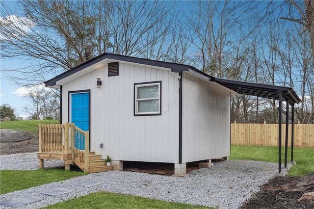 view of outbuilding featuring a lawn