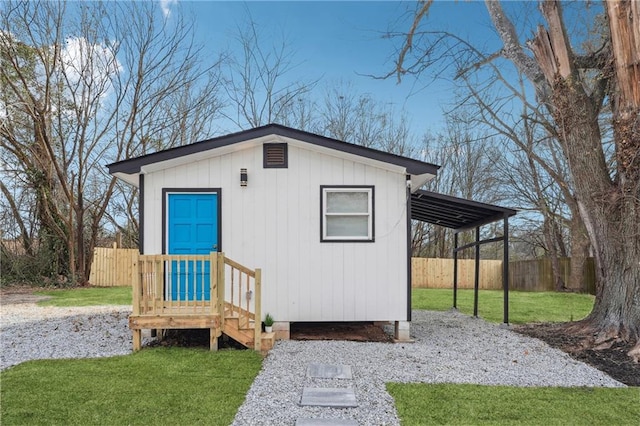 view of outbuilding featuring a lawn