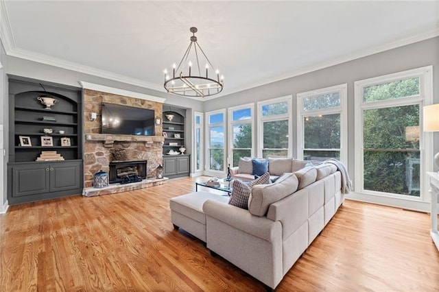 living room featuring a healthy amount of sunlight, built in features, and light wood-type flooring