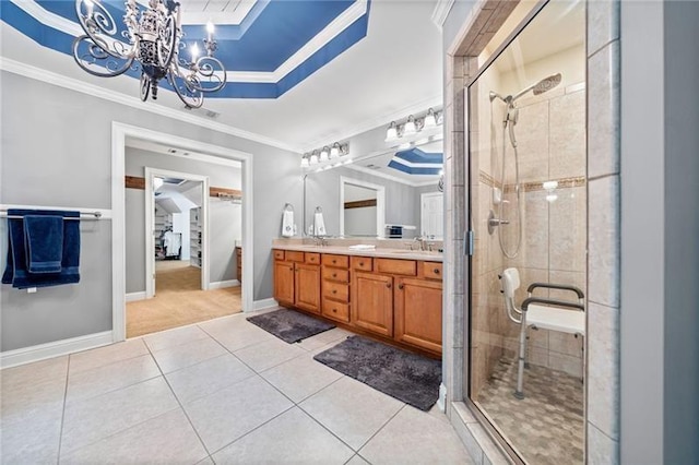 bathroom with an enclosed shower, crown molding, vanity, a raised ceiling, and tile patterned flooring