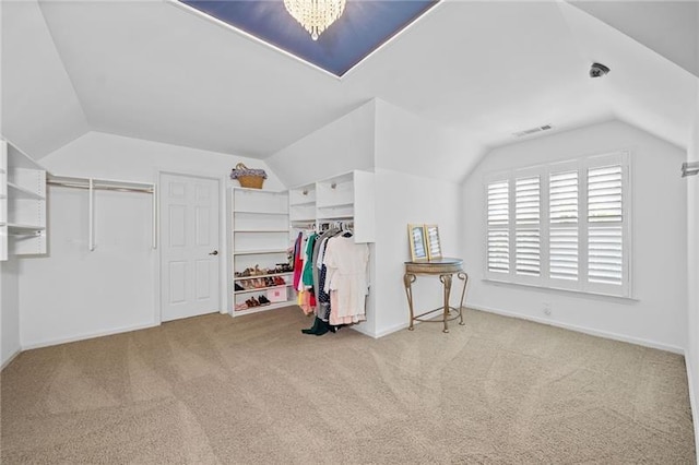 bonus room with vaulted ceiling, light carpet, and an inviting chandelier