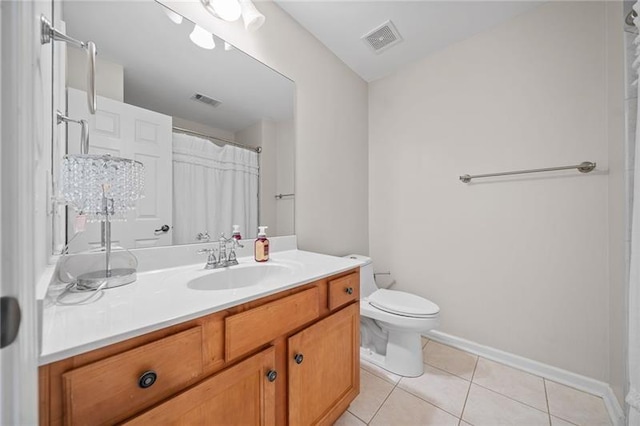 bathroom featuring tile patterned flooring, vanity, curtained shower, and toilet