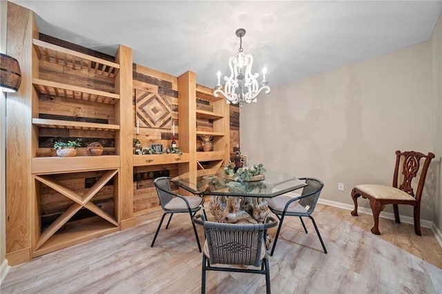 wine cellar with hardwood / wood-style floors, a notable chandelier, and built in features