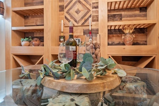 wine room with wooden walls and built in features