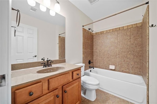 full bathroom featuring tile patterned flooring, vanity, toilet, and tiled shower / bath