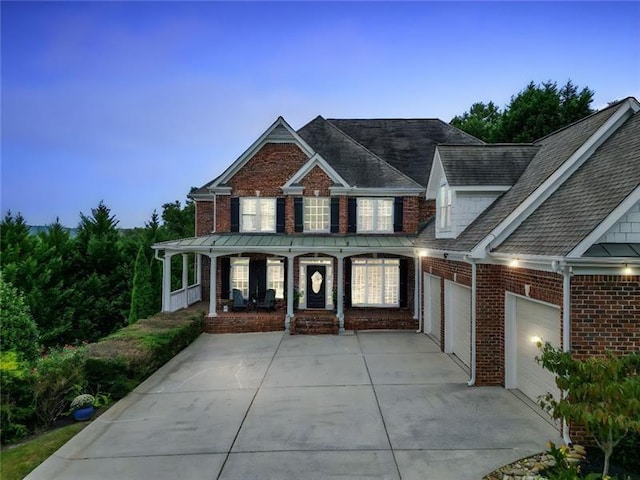 view of front of home featuring a porch and a garage