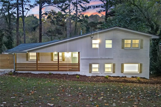 view of back house at dusk