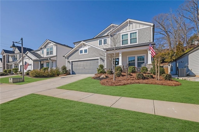 craftsman-style house featuring a garage, central AC, and a front lawn