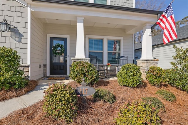 entrance to property featuring a porch