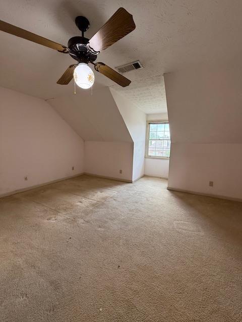 corridor featuring light carpet and attic access