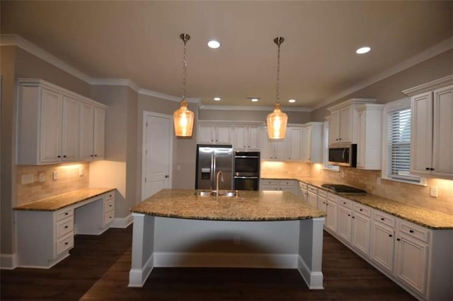 kitchen with pendant lighting, a kitchen island with sink, white cabinets, light stone countertops, and stainless steel appliances