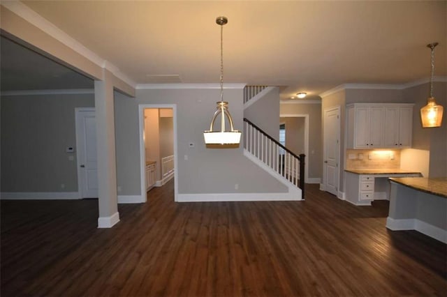 unfurnished living room featuring dark hardwood / wood-style floors and ornamental molding