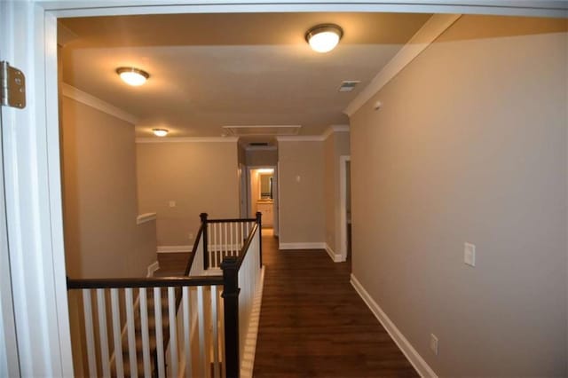 hall with dark wood-type flooring and crown molding