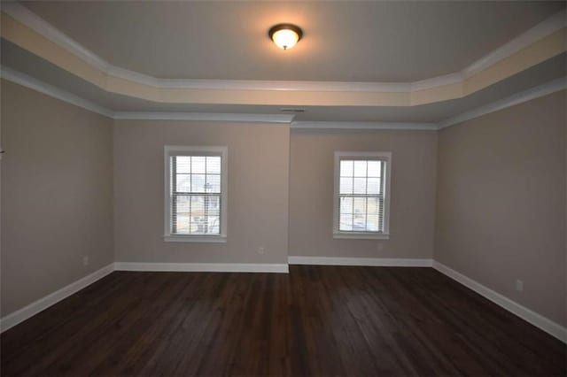 spare room with a healthy amount of sunlight, dark hardwood / wood-style flooring, and ornamental molding