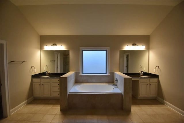 bathroom with tile patterned floors, separate shower and tub, vanity, and lofted ceiling