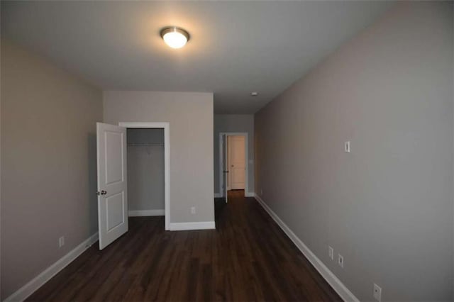 unfurnished bedroom featuring dark hardwood / wood-style flooring and a closet