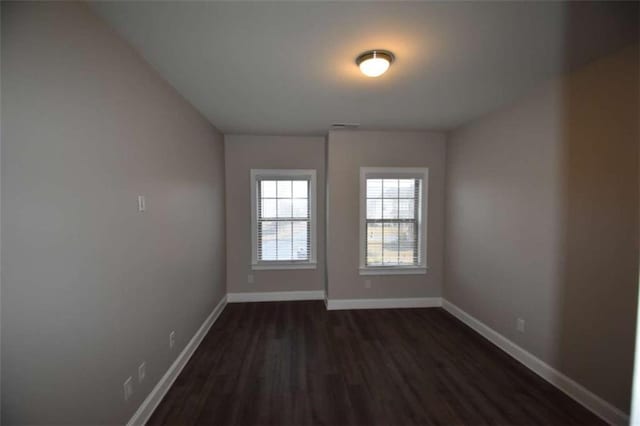 unfurnished room featuring dark hardwood / wood-style floors