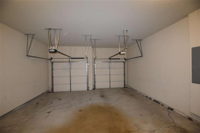 garage with electric panel and a garage door opener