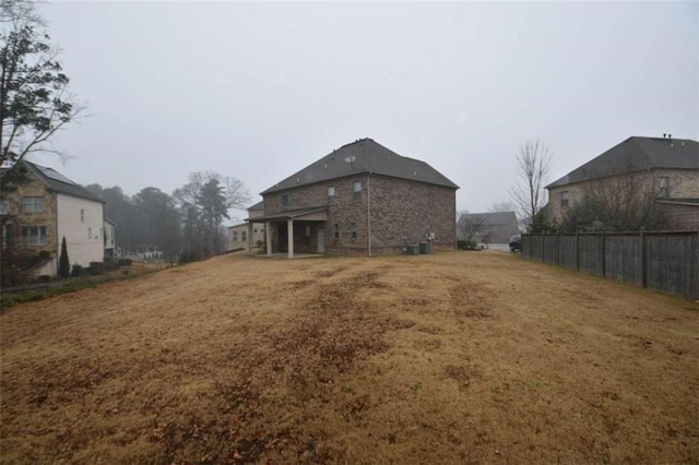 back of house with a lawn