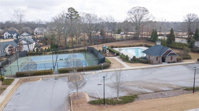 view of pool with tennis court