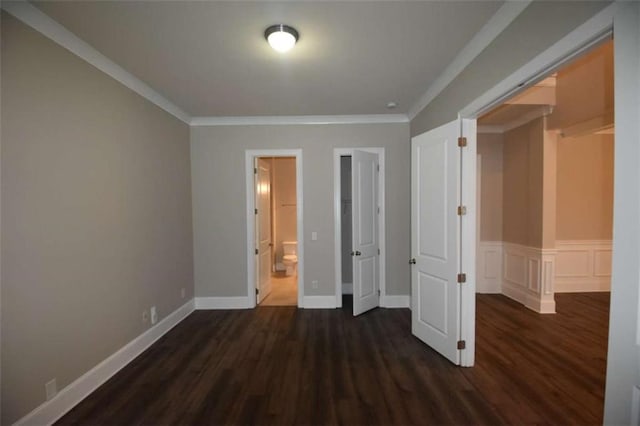 unfurnished bedroom with dark hardwood / wood-style floors, a closet, crown molding, and ensuite bath