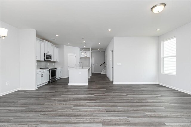 805 York Aly, Acworth, GA 30102 - kitchen with stainless steel appliances, open floor plan, a center island with sink, white cabinetry, and wood finished floors