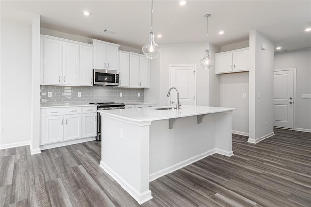 805 York Aly, Acworth, GA 30102 - kitchen featuring appliances with stainless steel finishes, dark wood-type flooring, white cabinets, a center island with sink, and recessed lighting