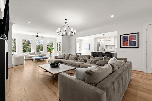 living room featuring recessed lighting, light wood-type flooring, and a chandelier