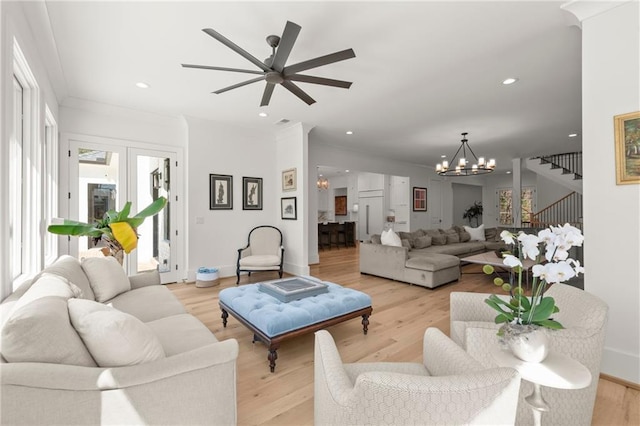 living room featuring stairway, light wood-style flooring, and recessed lighting