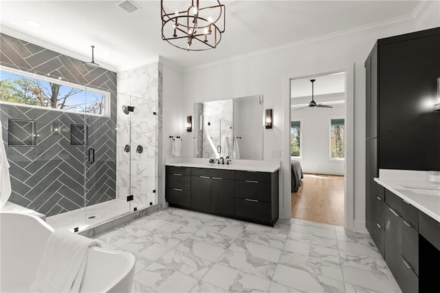 full bath with marble finish floor, crown molding, a shower stall, and two vanities