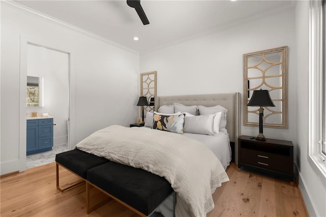 bedroom featuring a ceiling fan, ensuite bath, recessed lighting, ornamental molding, and light wood-type flooring