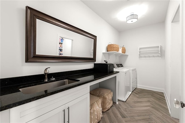 laundry area featuring a sink, baseboards, independent washer and dryer, and laundry area