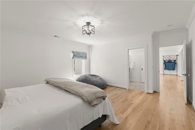 bedroom with visible vents, baseboards, an inviting chandelier, crown molding, and light wood-type flooring