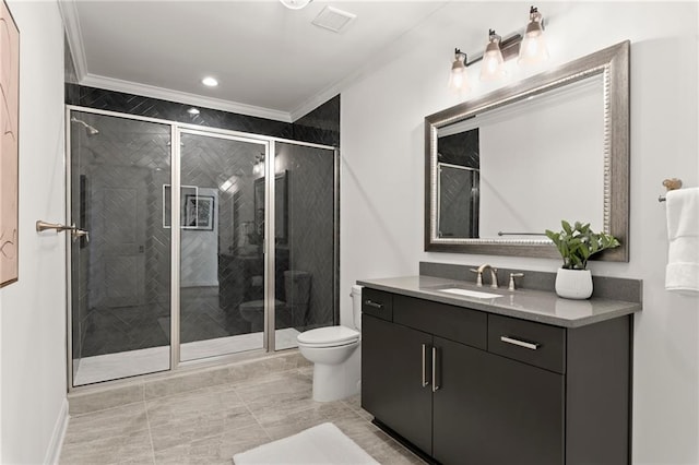 bathroom with vanity, visible vents, a shower stall, crown molding, and toilet